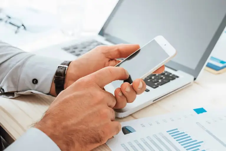 man-calculates-finances-with-smartphone-mobile