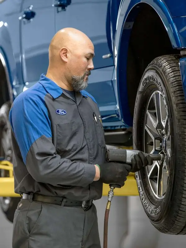 Ford Mechanic Inspecting oil pan at Napleton Ford Columbus